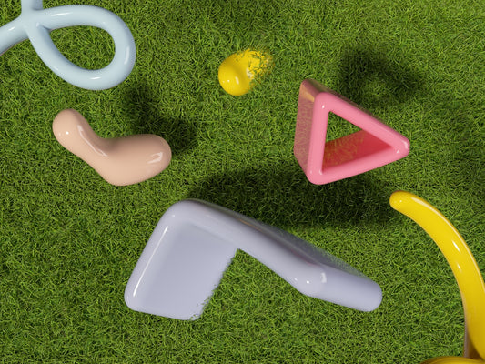 a group of plastic toys laying on top of a green field