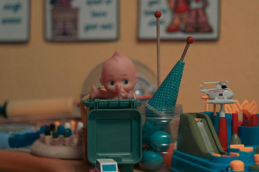 A table topped with toys and a cell phone